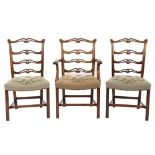 A set of eight 19th Century carved mahogany ladderback dining chairs:, in the George III taste,