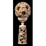 A Canton carved and pierced ivory puzzle ball and stand: of traditional form with ten graduated