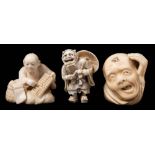 A group of two Japanese carved ivory netsukes together with an okimono: the first netsuke in the