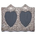 An Elizabeth II silver embossed double heart easel photograph frame, maker Paul Vernon Fitchie,