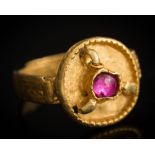 A Saxon migration period gold ring: inset with a later single cabochon ruby,