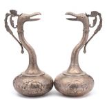 A pair of Indo-Persian silver ewers: each of squat globular form with slender curved neck and spout