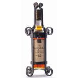 A bottle of Macallan 10 year old single malt whisky:, in a wrought iron cage with padlock clasp.