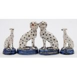 Two pairs of Staffordshire pottery Dalmatians: both in seated posture,