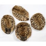 A set of four late Victorian/early Edwardian leopard skin foot warmers, circa 1900,