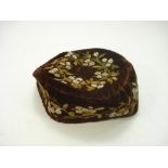 A late Victorian brown silk embroidered smoking hat:,with floral decoration.