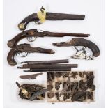 A collection of 18th century and later flintlock and percussion cap pistol fittings including parts