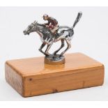 A chrome plated Racing horse car mascot: with jockey up, painted in red and white silks,