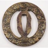 A 19th century Japanese brass tsuba:, with open frame and scrolling wave decorated border, 7.