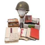 A collection of miscellaneous militaria:, including a 1979 British steel helmet,