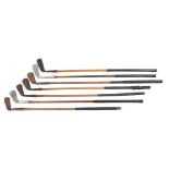 A group of seven early 20th century hickory shaft golf clubs:,