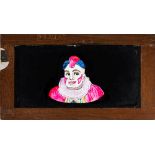 A magic lantern slipping side of a clown with moving eyes:, unsigned, in a mahogany frame.