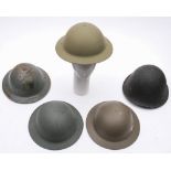 A group of five WWII and later steel helmets:. (5).