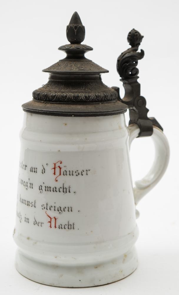 A late 19th century German porcelain Bierstein with lithophane base: the spelter lidded top above