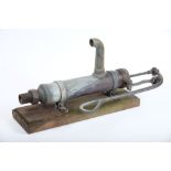 A Danish bronze and brass boat pump by Wigo:, mounted on a wooden plinth,