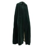 A Quad green velvet cape:, with quilted lining and black frogging to collar,