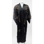 A mid 20th century black silk kimono with embroidered dragon decoration:, .