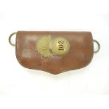 A brown leather cartridge pouch with a British Indian 102nd Royal Madras Fusilier's glengarry badge