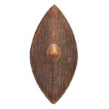 A West African woven parrying shield: of oval design with central wood boss,