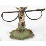 A cast iron Coalbrookdale style stick stand in the form of a begging dog with riding whip in its