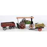 A Mamod live steam traction engine:, in white and green with red spoked wheels,