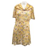 An early 20th century lady's blue cotton printed blouse:, a yellow cotton floral printed dress,