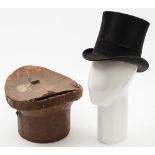 A black felt top hat by Christys London in a brown leather hat box: (damaged) size 61/2,