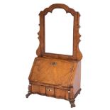 A walnut and inlaid swing frame toilet mirror in the early 18th Century taste:,