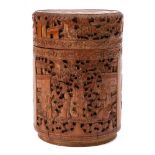 A Chinese carved bamboo cylindrical box and cover: carved overall with figures on terraces, phoenix,