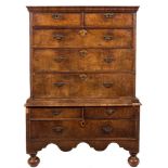 An early 18th Century walnut and crossbanded chest on stand:, the upper part with a moulded cornice,