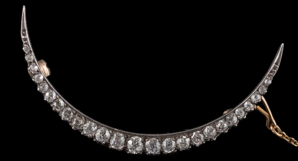 A late 19th century gold and diamond crescent brooch: with graduated round old,