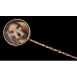 A stick pin with circular enamelled plaque depicting head of hound: in closed back setting,