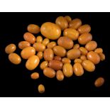 A collection of 43 amber beads: ranging 12mm long x 9mm wide, to 32mm long x 25mm wide,
