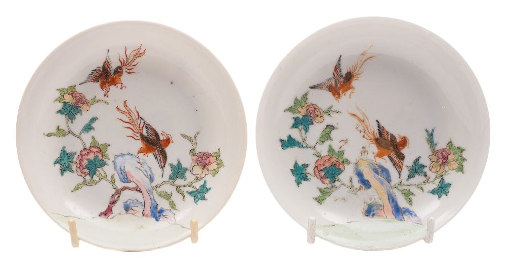 A pair of Chinese famille rose saucers: each finely painted with two phoenix,