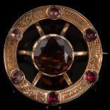 A late 19th century gold Celtic circular brooch: with central round cairngorm approximately 18.
