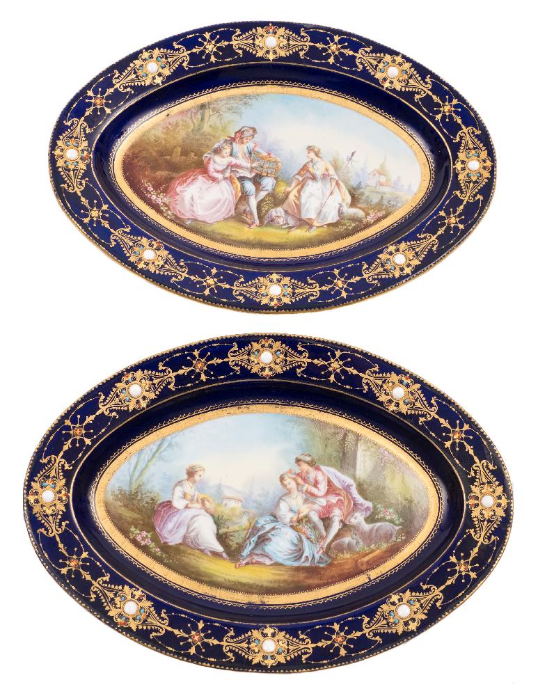 A pair of Sevres-style oval dishes: painted in the manner of Fragonard with courting couples in