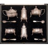 A George V hammered silver six-piece cruet set, maker Goldsmiths & Silversmiths Co Ltd, London,