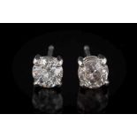 A pair of platinum and diamond single-stone ear-studs: each with a round old brilliant-cut diamond