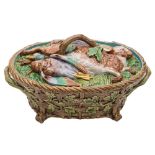 A Minton majolica game pie dish and cover: the cover moulded with dead game on a bed of ferns,