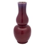 A Chinese flambé double gourd vase: the bulbous body covered in a thick red and purple streaked