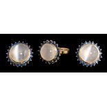 A cat's eye moonstone and sapphire circular cluster ring with matching ear-clips: each ear-clip