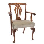 An 18th Century carved walnut and fruitwood elbow chair:, in the Chippendale taste,