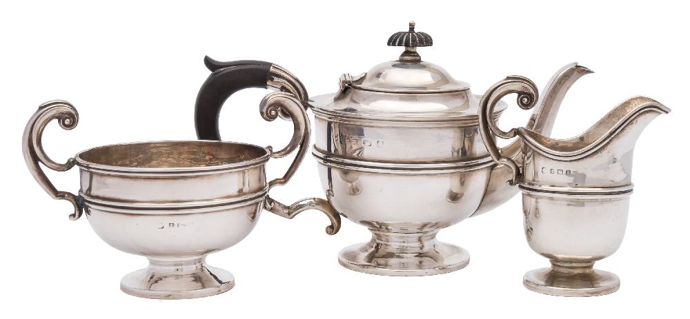 A George V silver three-piece tea service, maker's marks worn, Birmingham,