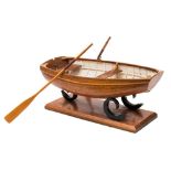 A clinker built model of a dinghy:, with ribbed varnished hull,