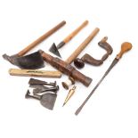 A collection of shipwright's tools:, including a caulking mallet, an adze,