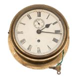 A brass cased bulkhead clock:, the single barrel movement with white dial,