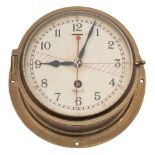 A brass cased radio room bulkhead clock by Mercer:,