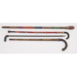 Ray Tucknott, two multicoloured ropework walking canes and two other ropework walking sticks:.