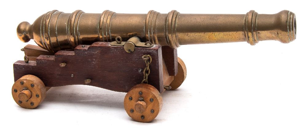 A brass desk model of a cannon: on a Royal Navy style truck, 26cm long.