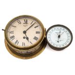 A brass eight day bulkhead clock by Smiths, London:, white enamel dial with Roman numerals,